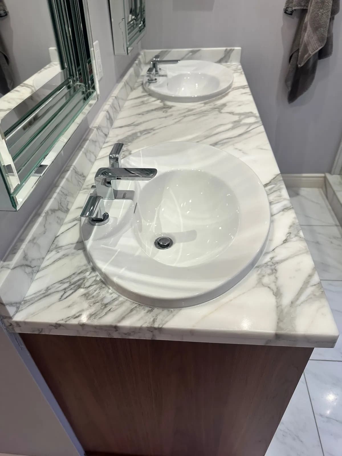Polished white marble double vanity with grey veining