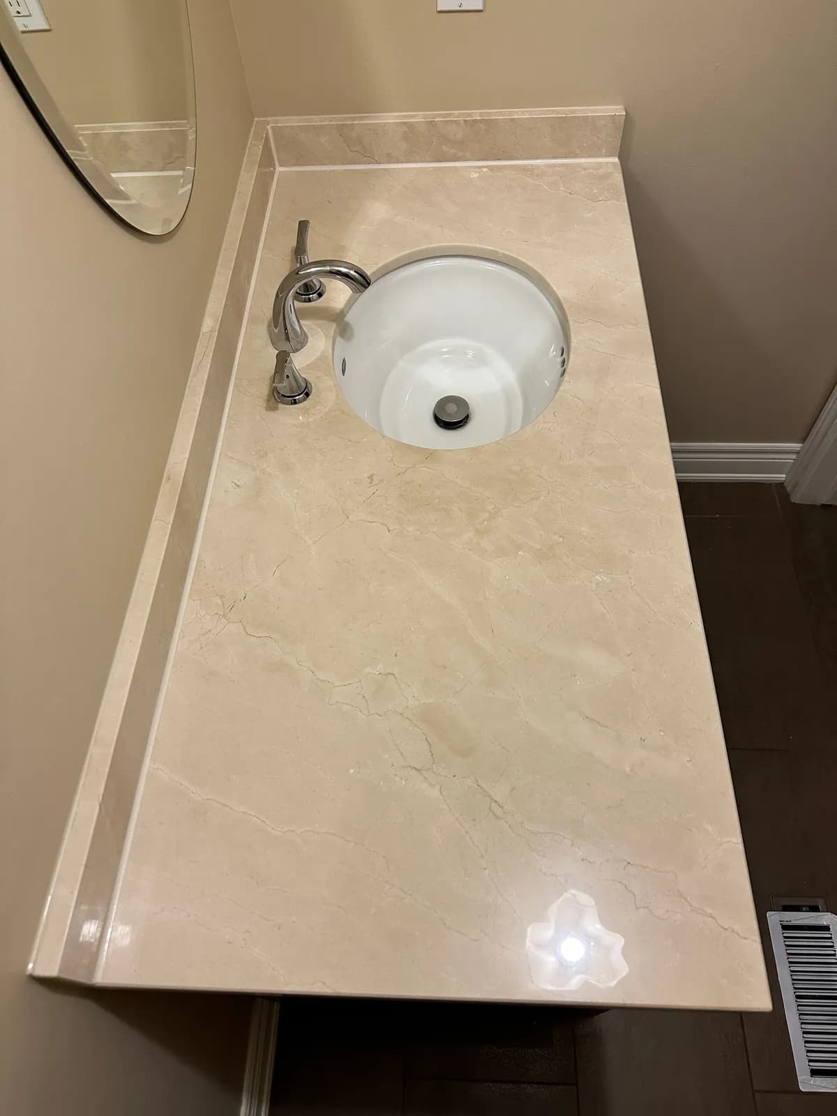 Polished cream marble vanity top with an undermount sink