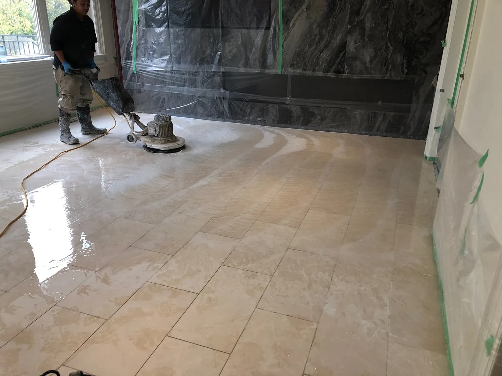 A Marble Clinic technician honing a marble floor