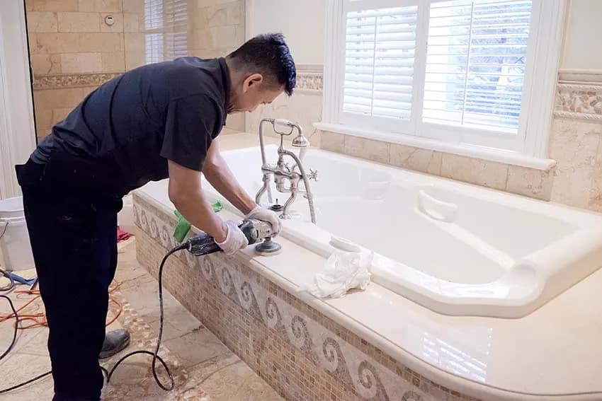 Technician polishing a marble tub deck