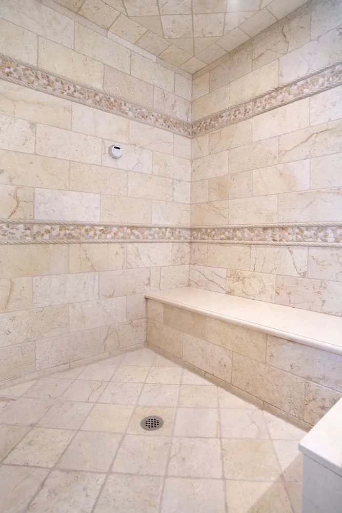 Stone steam shower with a built-in bench after restoration