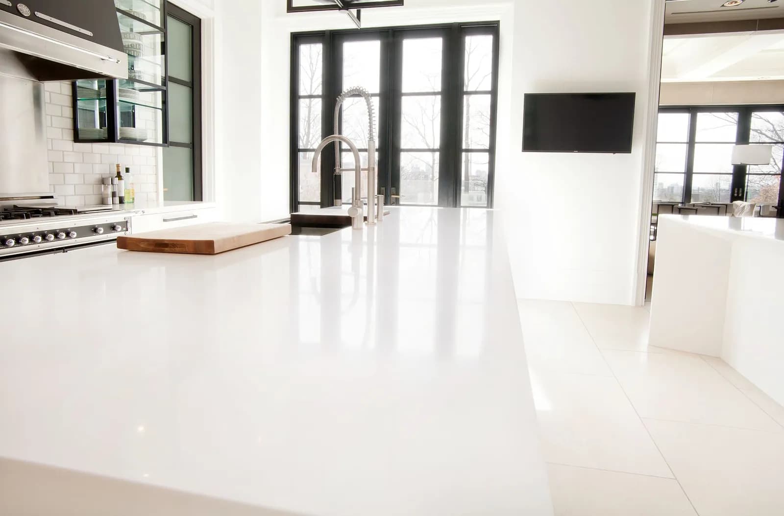White kitchen island and pale stone floor after restoration
