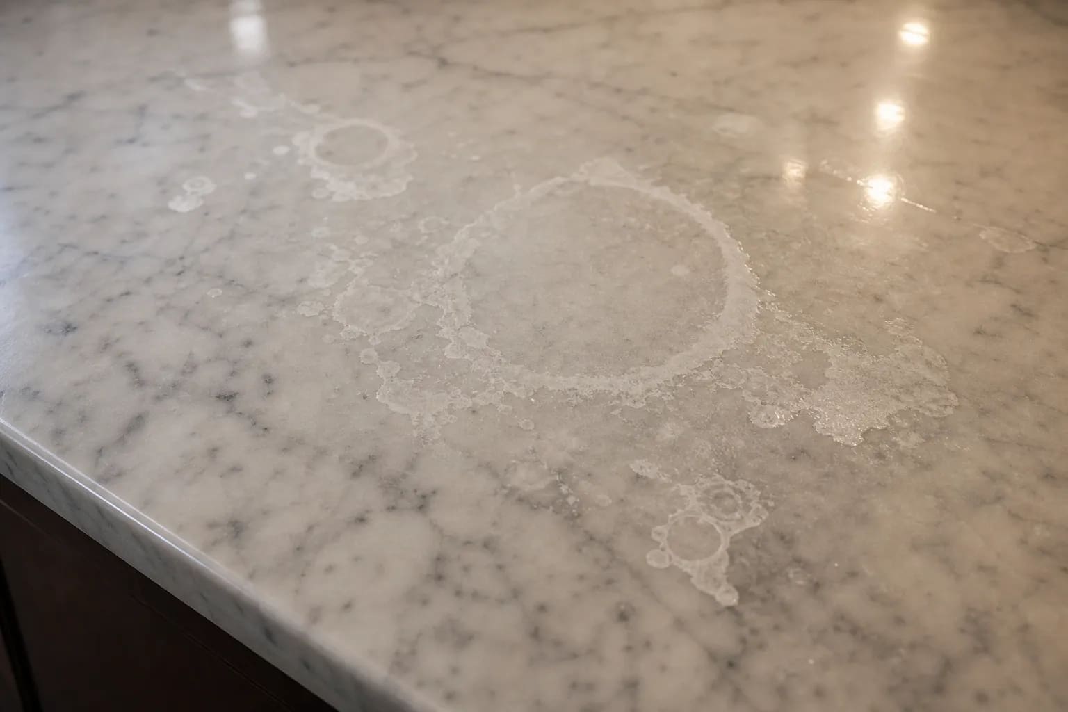 Marble countertop with dull etch rings and cloudy acid marks