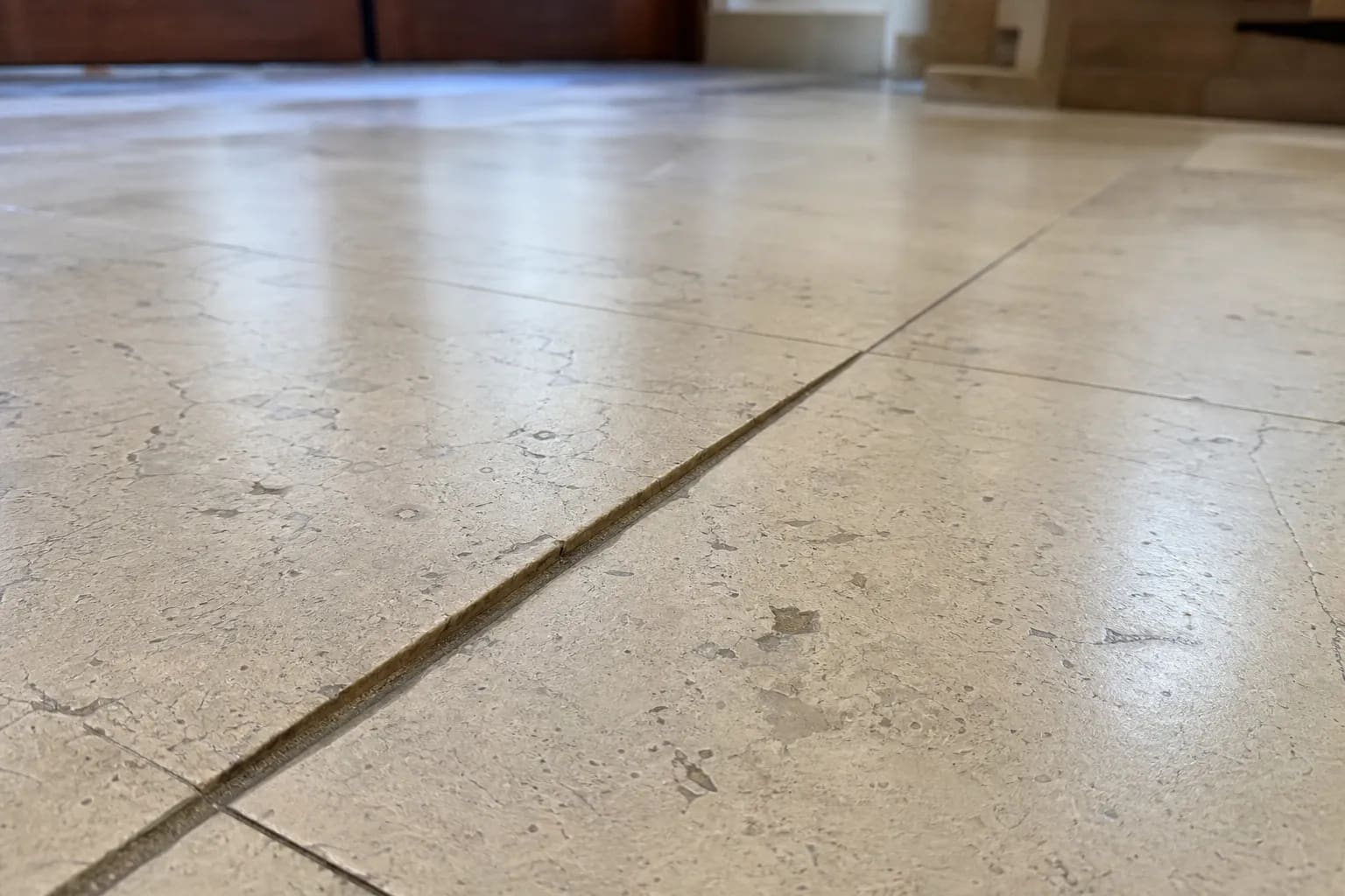 Marble floor tiles with lippage, where neighbouring tiles sit at different heights
