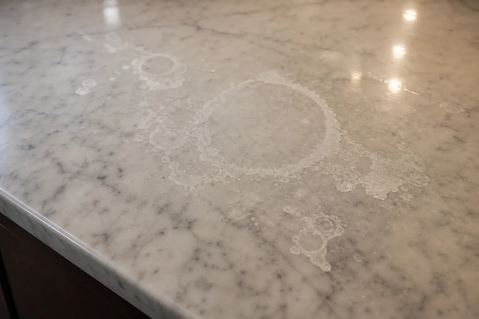 Marble countertop with dull etch rings and cloudy acid marks