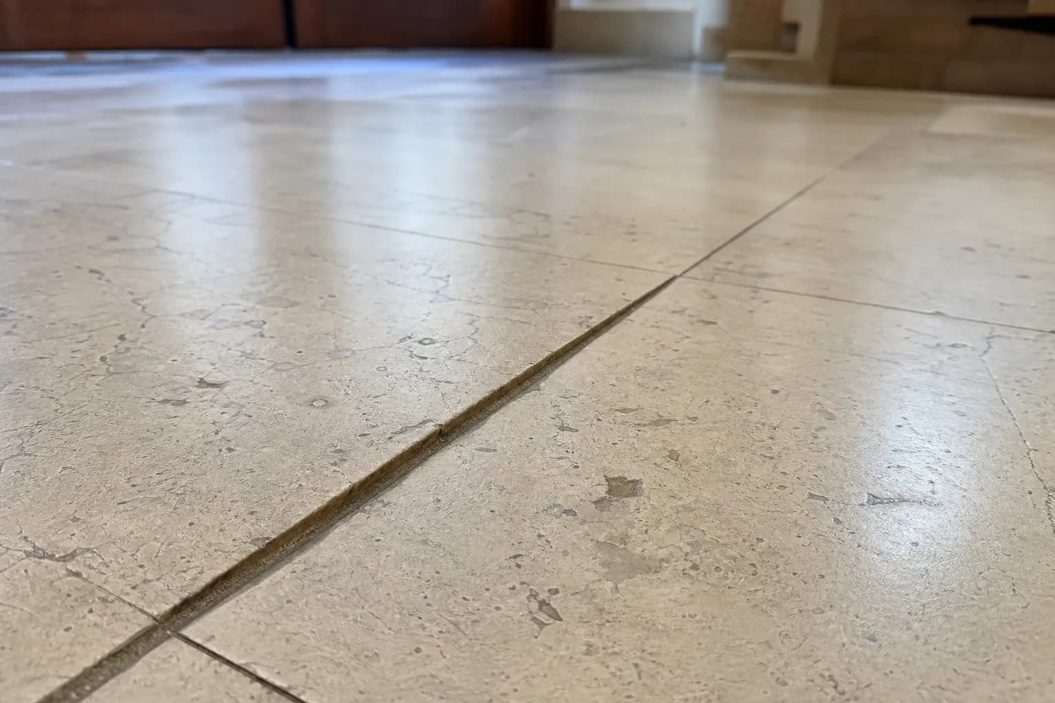 Marble floor tiles with lippage, where neighbouring tiles sit at different heights