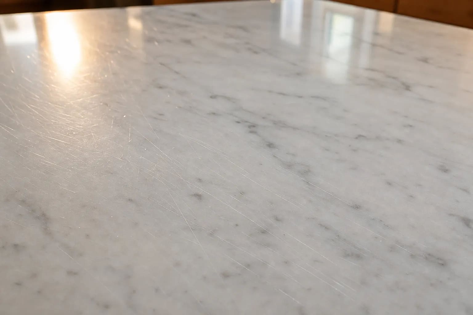 Fine scratch lines across the prep area of a polished marble countertop
