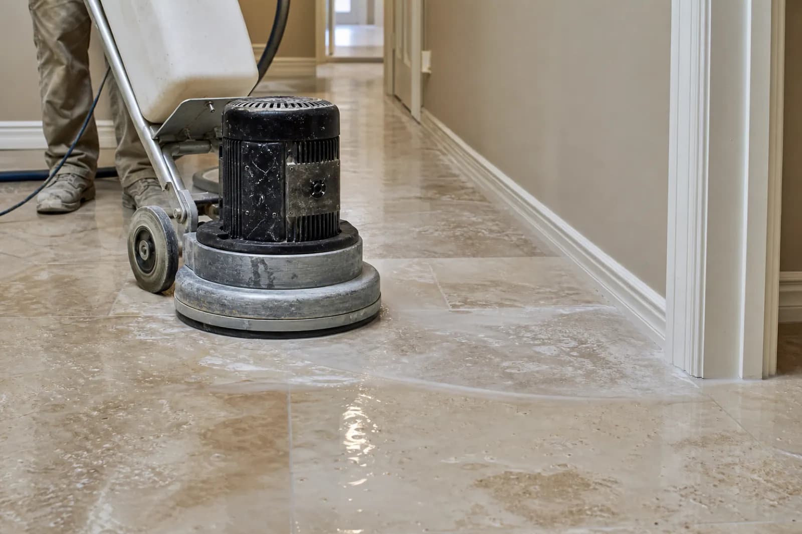 Diamond grinder flattening an uneven stone tile floor