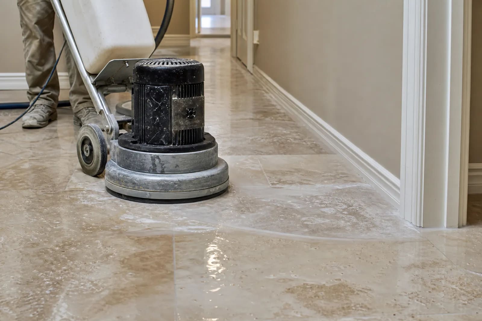 Diamond grinder flattening an uneven stone tile floor