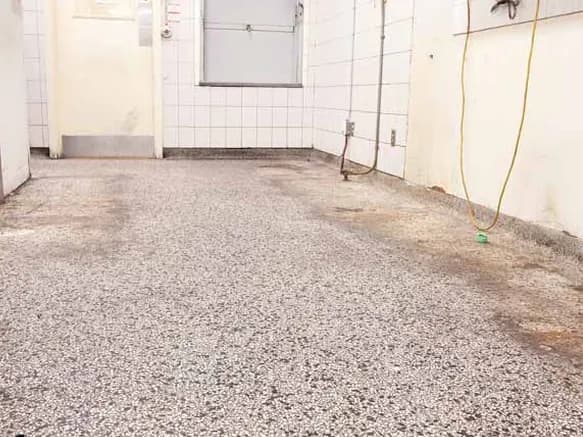 Rust-stained terrazzo floor before restoration